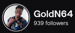 GoldN64's Twitch logo and follower count (939). Logo is a picture of a smiling black man wearing a floral-like shirt. Image links to GoldN64's Twitch page.