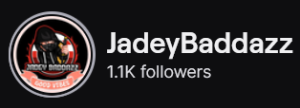 JadeyBaddazz' Twitch logo and follower count (1.1k). Logo is a black man wearing a hoodie and face mask, holding a sword. Image links to JadeyBaddazz' Twitch page.