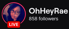 OhHeyRae's Twitch logo and follower count (858). Logo is a picture of an afro-latina woman with long and wavy black hair, wearing oversized frame glasses. Image links to OhHeyRae's Twitch page.