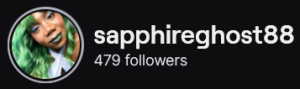 SapphireGhost88's Twitch logo and follower count (479). Logo is a picture of a black woman with jade green hair and lips. Image links to SapphireGhost88's Twitch page.
